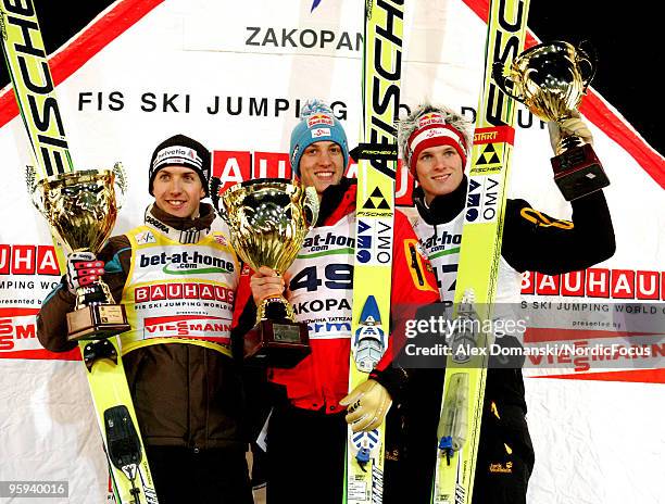 Simon Ammann of Switzerland , Gregor Schlierenzauer of Austria and Thomas Morgenstern of Austria celebrate on the podium after the FIS Ski Jumping...