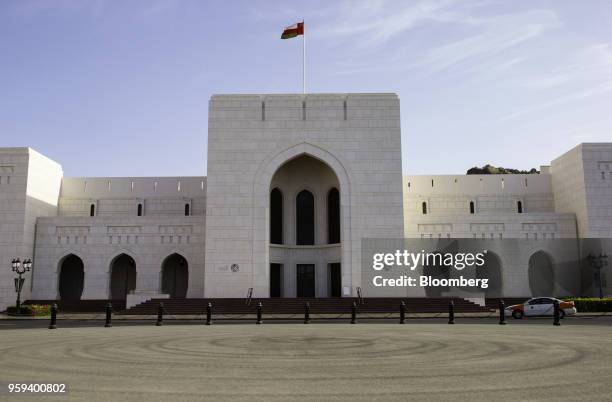 An Omani national flag flies above the National Museum in Muscat, Oman, on Sunday, May 6, 2018. Being the Switzerland of the Gulf served the country...