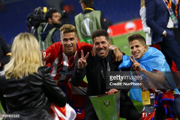 Diego Simeone manager of Atletico with the sons Giuliano and Gianluca posing with the trophy at Groupama Stadium in Lyon, France on May 16, 2018...