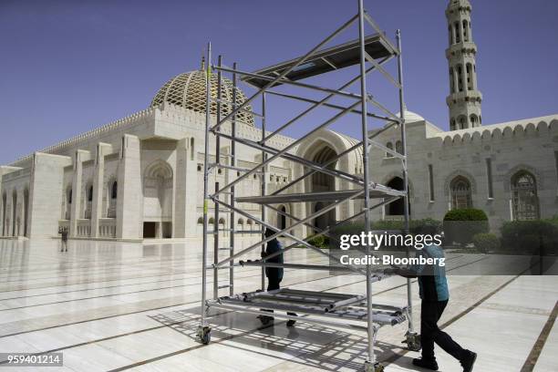 Workers wheel a scaffolding platform through the grounds of the Sultan Qaboos Grand Mosque in Muscat, Oman, on Sunday, May 6, 2018. Being the...