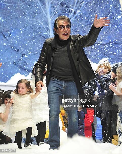 Italian designer Roberto Cavalli waves on the catwalk with children at the end of his fashion show for the labels "Roberto Cavalli Angels" and...