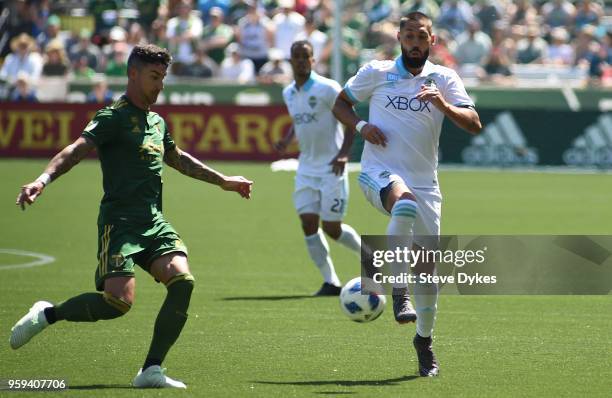 Clint Dempsey of Seattle Sounders goes after a ball against Liam Ridgewell of Portland Timbers during the second half of the match against the...