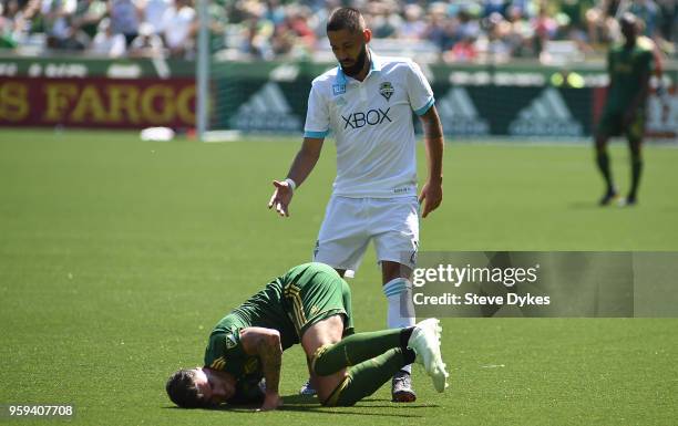 Clint Dempsey of Seattle Sounders goes after a ball against Liam Ridgewell of Portland Timbers during the second half of the match against the...