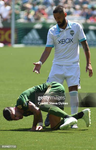 Clint Dempsey of Seattle Sounders goes after a ball against Liam Ridgewell of Portland Timbers during the second half of the match against the...