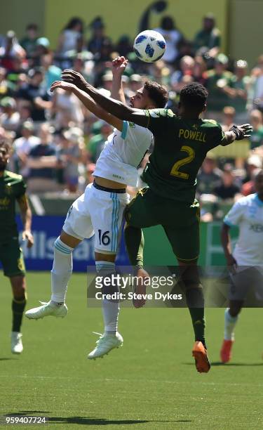 Alex Roldan of Seattle Sounders and Alvas Powell of Portland Timbers go up for a ball during the second half of the match against the Portland...