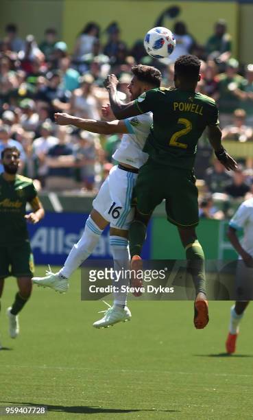 Alex Roldan of Seattle Sounders and Alvas Powell of Portland Timbers go up for a ball during the second half of the match against the Portland...