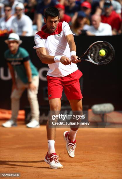 Novak Djokovic of Serbia plays a backhand in his match against Nikoloz Basilashvili of Georgia during day four of the Internazionali BNL d'Italia...