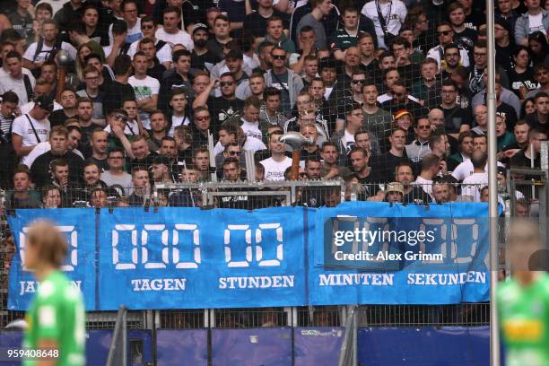 Fans of Moenchengladbach show a banner with the remaining time of Hamburg in the Bundesliga after the Bundesliga match between Hamburger SV and...