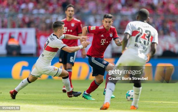 James Rodriguez of FC Bayern Muenchen is challenged by players of VfB Stuttgart during the Bundesliga match between FC Bayern Muenchen and VfB...