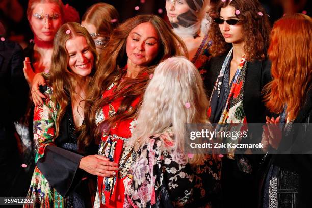 Designer Camilla Franks embraces models Emma Balfourand Sarah Jane Adams following the Camilla show at Mercedes-Benz Fashion Week Resort 19...