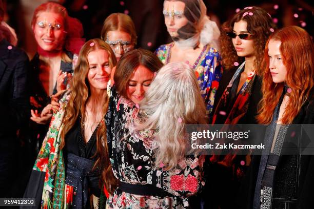 Designer Camilla Franks embraces models Emma Balfourand Sarah Jane Adams following the Camilla show at Mercedes-Benz Fashion Week Resort 19...