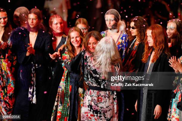 Designer Camilla Franks embraces models Emma Balfourand Sarah Jane Adams following the Camilla show at Mercedes-Benz Fashion Week Resort 19...