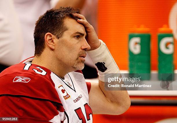 Quarterback Kurt Warner of the Arizona Cardinals looks on dejected from the bench in the second half against the New Orleans Saints during the NFC...