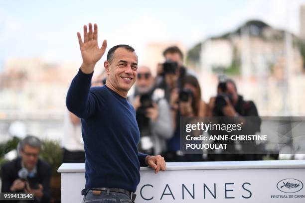 Italian director Matteo Garrone waves on May 17, 2018 during a photocall for the film "Dogman" at the 71st edition of the Cannes Film Festival in...