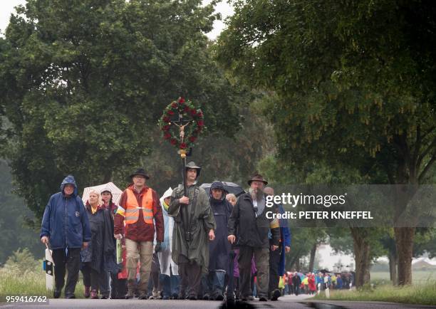 People take part in a pilgrimage on foot on a 111km long tour from Regensburg to Altoetting, in Niedertraubling, southern Germany, on May 17, 2018. /...