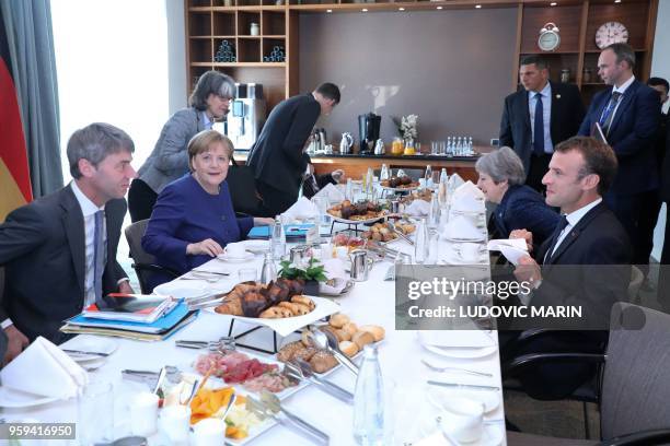 French President Emmanuel Macron , British Prime Minister Theresa May and German Chancellor Angela Merkel attend a breakfast meeting at the start of...