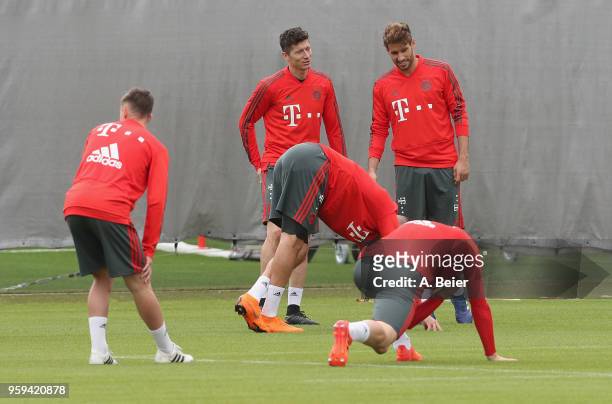 Javi Martinez and Robert Lewandowski of FC Bayern Muenchen warm up during a training session at the club's Saebener Strasse training ground on May...