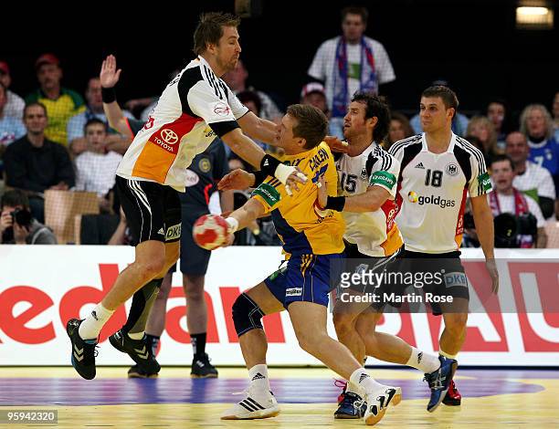 Oliver Roggisch and Torsten Jansen of Germany challenge with Oscar Carlen of Sweden during the Men's Handball European Championship Group C match...