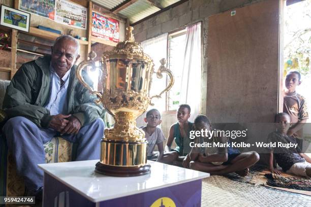 Apakuki Saisai and his family and friends sit with the Webb Ellis Cup in his house during Rugby World Cup 2019 Trophy Tour on May 17, 2018 in Galoa...