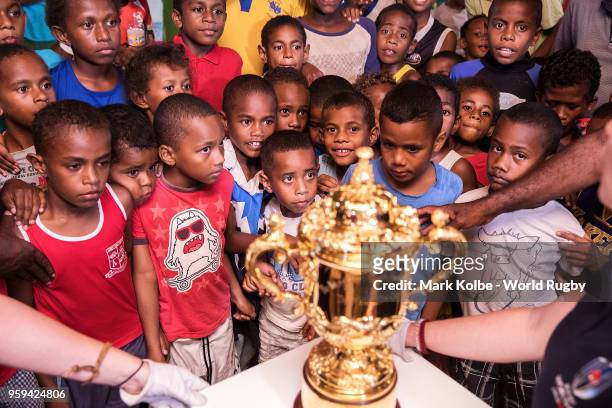 Children view the Webb Ellis Cup in the Galoa village hall during Rugby World Cup 2019 Trophy Tour on May 17, 2018 in Galoa village, Fiji.