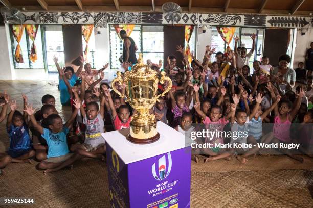 Children cheer as they view the Webb Ellis Cup in the Galoa village hall during Rugby World Cup 2019 Trophy Tour on May 17, 2018 in Galoa, Fiji.