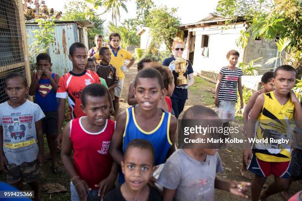 Children walk with the Webb Ellis Cup as it is carried to the Galoa village hall during Rugby World Cup 2019 Trophy Tour on May 17, 2018 in Galoa...
