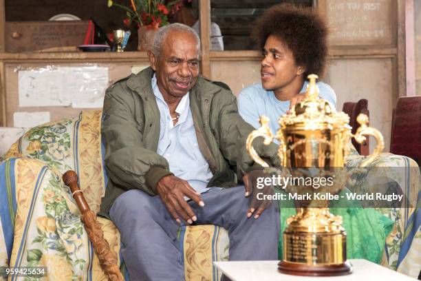 Apakuki Saisai and his family and friends sit with the Webb Ellis Cup in his house during Rugby World Cup 2019 Trophy Tour on May 17, 2018 in Galoa...