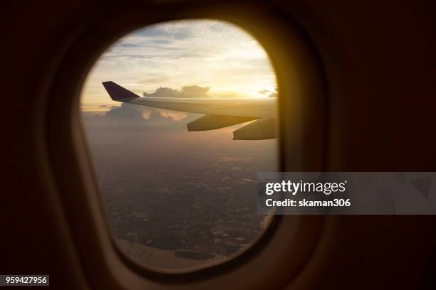 view of window seat on board of airplane - jet ski stock-fotos und bilder
