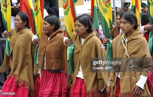 Bolivian indigenous women from the Aymara ethnic group parade with Bolivian flags January 22, 2010 in front the Palacio Quemado presidential palace...