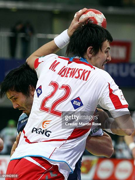 Marcin Lijewski of Poland shoots the ball against David Spiler of Slovenia during the Men's Handball European Championship Group C match between...