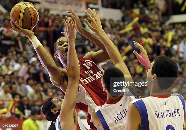 Giles of Lebanon's Al-Riyadi Sporting club competes with Philippines' Gilas club player during their Dubai International Basketball Tournament...