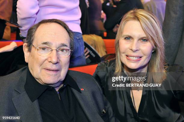 French director Robert Hossein and his wife Candice Patou pose before attending French singer Sylvie Vartan's show at the Palais des Congres on...