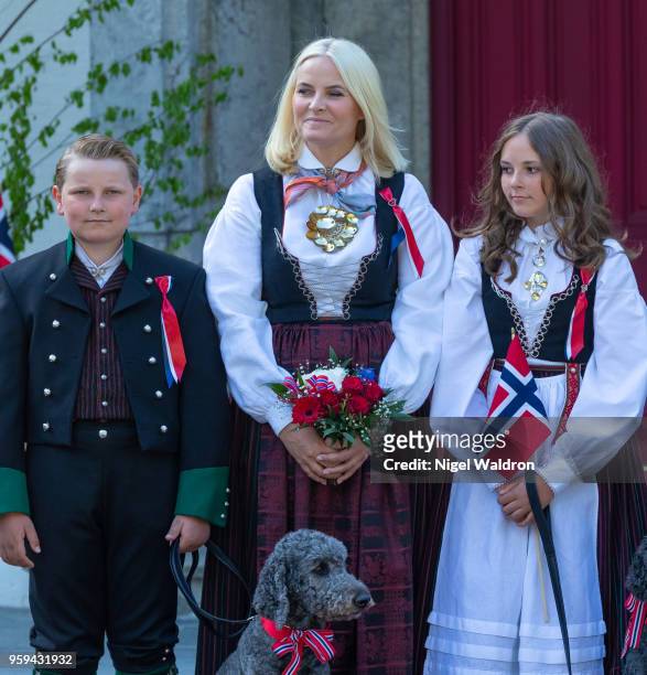 Prince Sverre Magnus of Norway, Princess Mette Marit of Norway and Princess Ingrid Alexandra of Norway wearing their national costumes and standing...