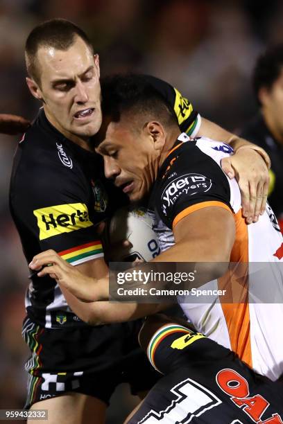 Sauaso Sue of the Tigers is tackled during the round 11 NRL match between the Penrith Panthers and the Wests Tigers at Panthers Stadium on May 17,...