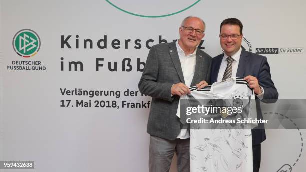 Treasurer Stephan Osnabruegge and Heinz Hilgers sign their contract extension at DFB Headquarter on May 17, 2018 in Frankfurt am Main, Germany.