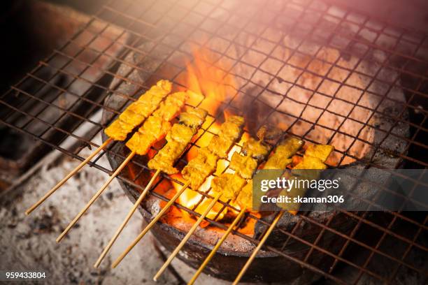 chicken satay grilled on grills plate with smoke - chicken satay stock pictures, royalty-free photos & images