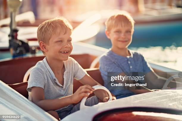 kids playing in a toy boat - amusement ride stock pictures, royalty-free photos & images