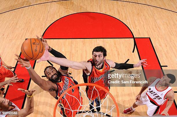 Ronny Turiaf and Vladimir Radmanovic the Golden State Warriors go after a loose ball during the game against the Portland Trail Blazers on January 2,...