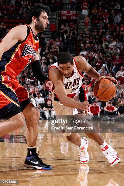 Andre Miller of the Portland Trail Blazers drives to the basket past Vladimir Radmanovic of the Golden State Warriors during the game on January 2,...