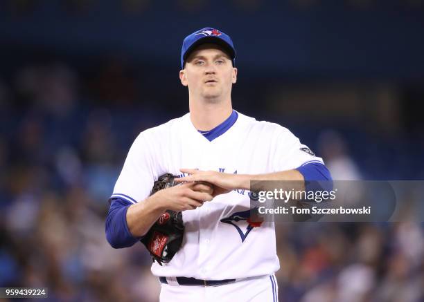 Jake Petricka of the Toronto Blue Jays rubs up a baseball in the seventh inning during MLB game action against the Boston Red Sox at Rogers Centre on...