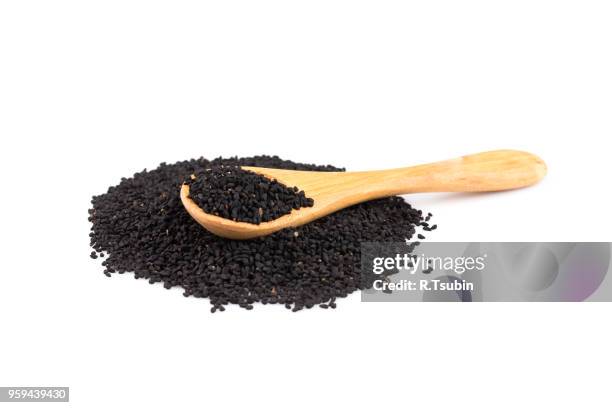 heap of black sesame on wooden spoon on white background - sesame stock pictures, royalty-free photos & images