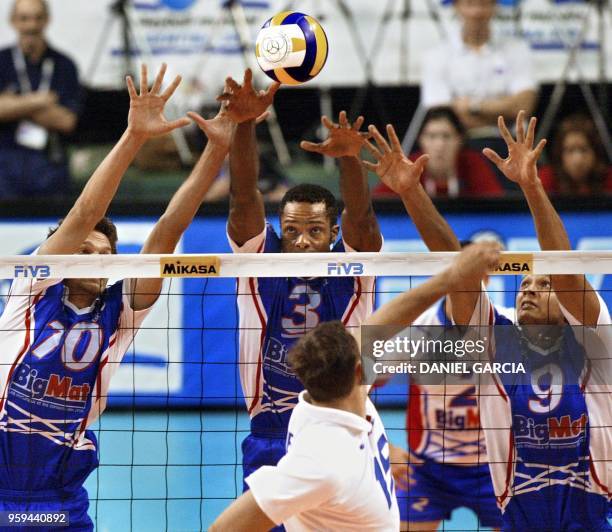 France's Vincent Montmeat, Dominique Daquin and Frantz Granvorka block the spike of Russia's Alexandre Guerassimov 30 September during their Group C...