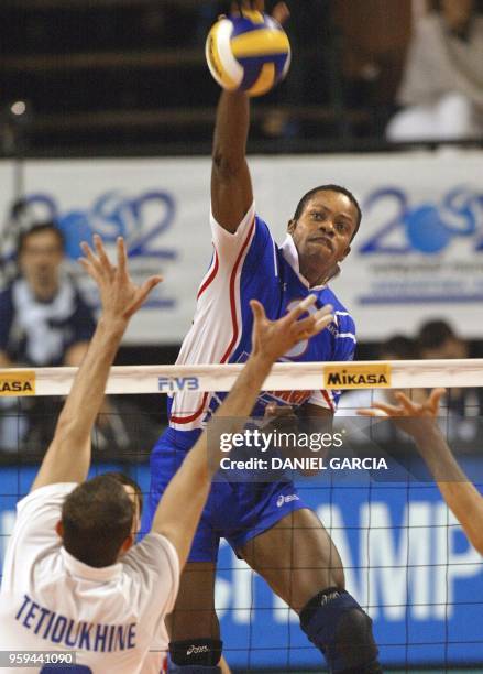 France's Dominique Daquin prepares to spike in front of Russia's Serguei Tetioukhine 30 September during their Group C match in the 2002 Volleyball...