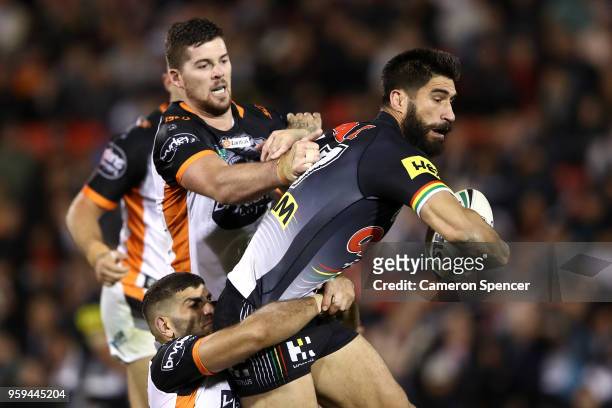 James Tamou of the Panthers is tackled during the round 11 NRL match between the Penrith Panthers and the Wests Tigers at Panthers Stadium on May 17,...