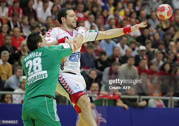 Jiri Vitek of Czech Republic vies with Timuzsin Schuch in Vienna, on January 22 during their Euro 2010 Group D Handball match, Czech Republic versus...