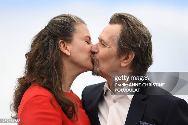 British actor Gary Oldman kisses his wife Gisele Schmidt on May 17, 2018 during a "Rendez-Vous with Gary Oldman" at the 71st edition of the Cannes...