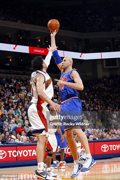 Zydrunas Ilgauskas of the Cleveland Cavaliers shoots over Vladimir Radmanovic of the Golden State Warriors during the game at Oracle Arena on January...