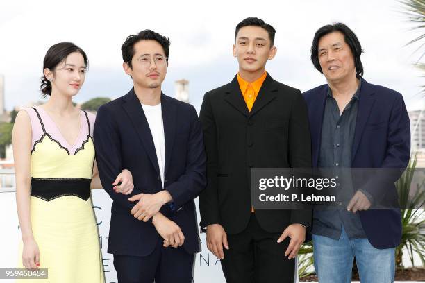 ) Director Chang-dong Lee, Ah-in Yoo, Steven Yeun and actress Jong-seo Jeon at the "Burning" photocall during the 71st Cannes Film Festival at the...