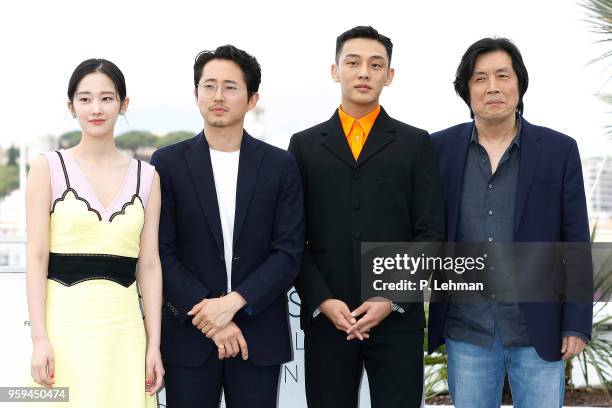 ) Director Chang-dong Lee, Ah-in Yoo, Steven Yeun and actress Jong-seo Jeon at the "Burning" photocall during the 71st Cannes Film Festival at the...