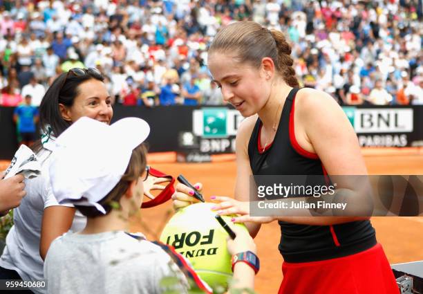 Jelena Ostapenko of Latvia signs autographs following victory in her singles match against Johanna Konta of Great Britain during day four of the...